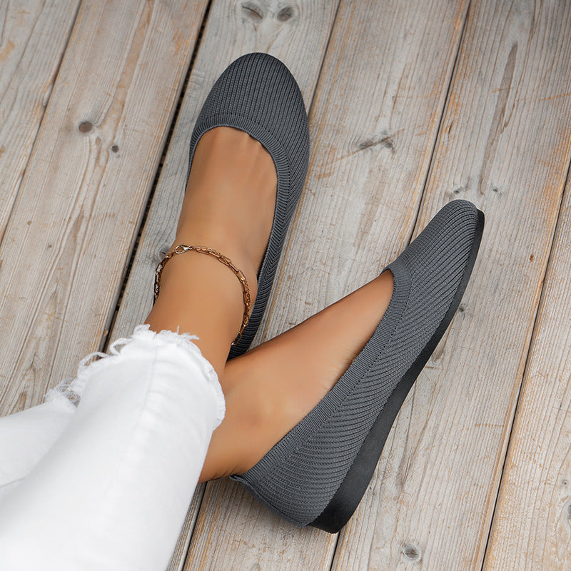 Dark gray orthopedic slip-on shoes with knit upper and rounded toe opening