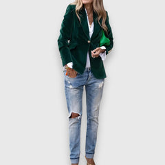 Women’s green blazer with notched lapels, single button, and front flap pockets