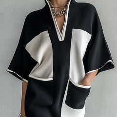 Black and white color-block midi dress with V-neck and contrast sleeve panels, front view