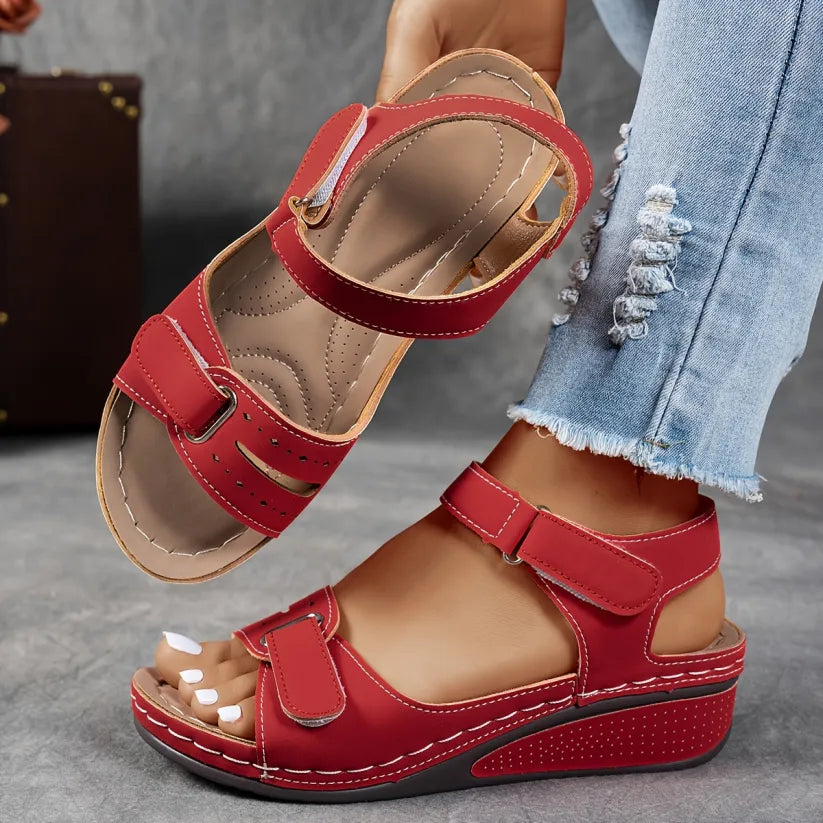 Red supportive wedge sandals with two buckled straps and open toe
