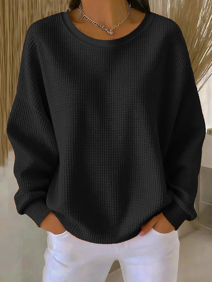 NYLA classic sweater in black waffle-knit, crewneck, long sleeves with ribbed cuffs.