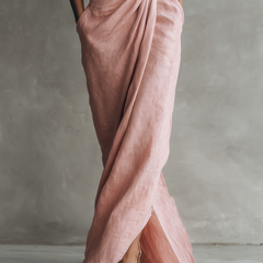 Pink linen-blend maxi dress showing side slit and draped knot waist detail
