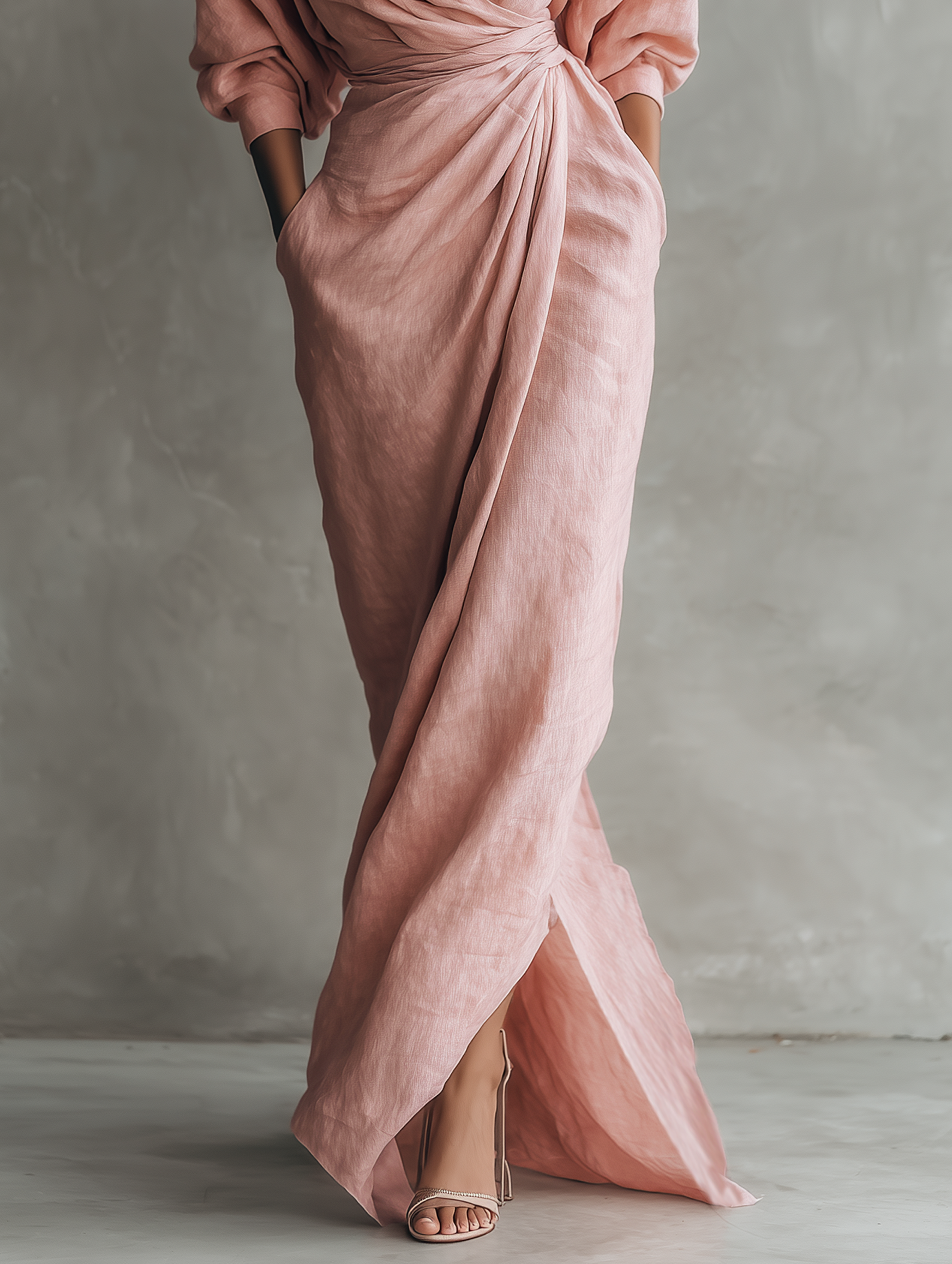 Pink linen-blend maxi dress showing side slit and draped knot waist detail