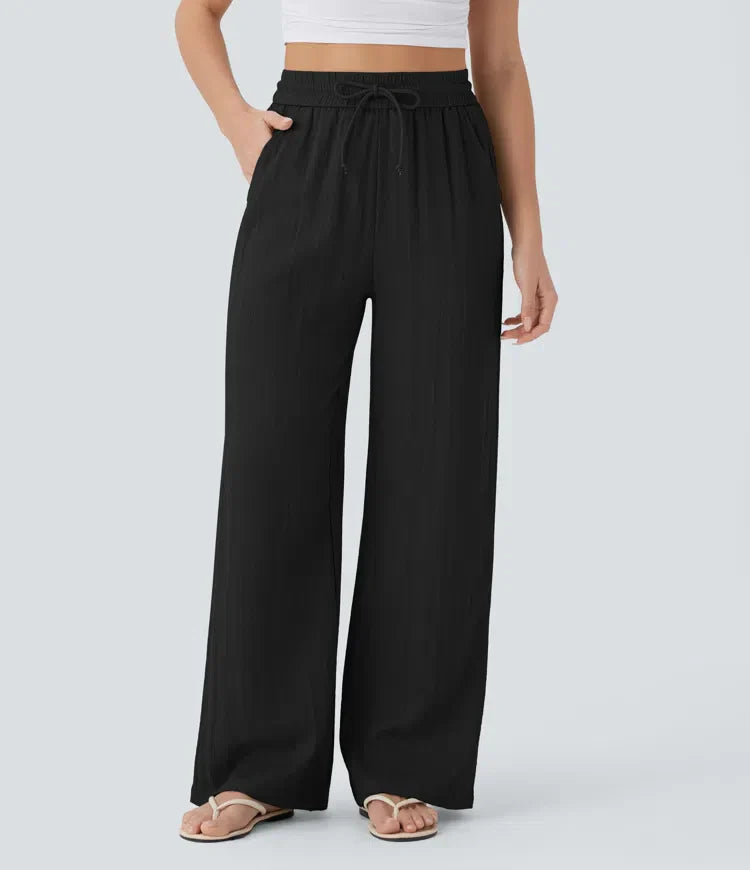 Black wide-leg trousers with elastic waistband and drawstring ties