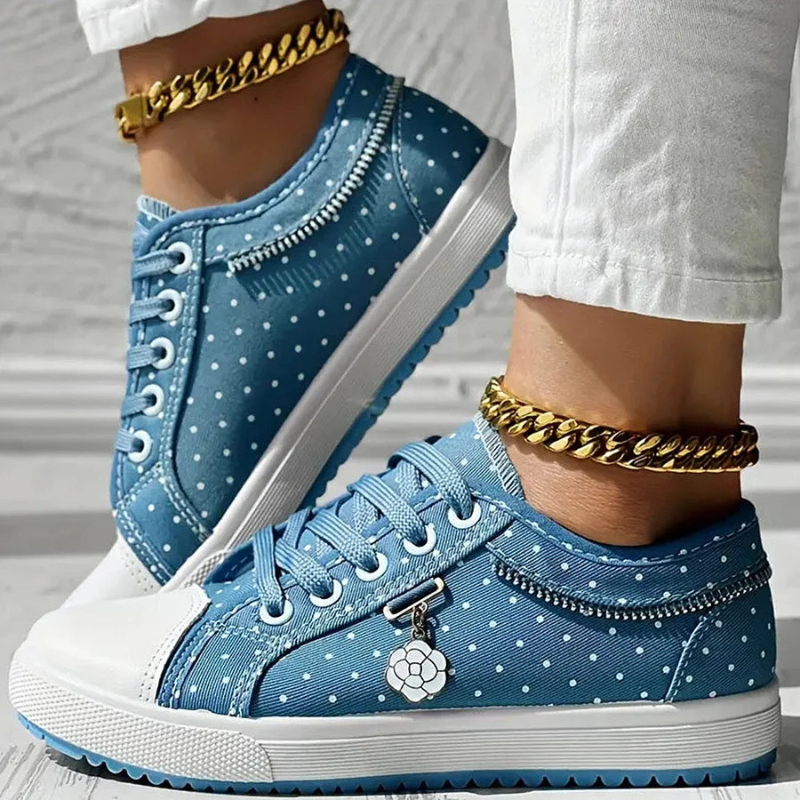 Light blue lace-up floral sneakers with dotted trim and white rubber sole, court-style.