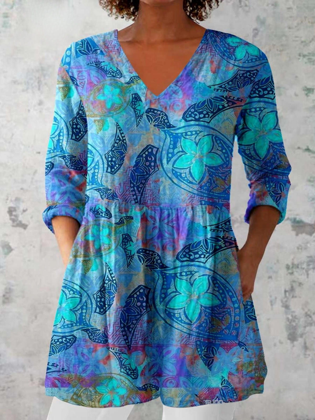 Women's long V-neck blouse in blue with colorful abstract print
