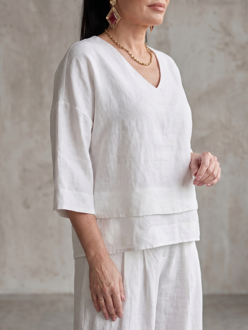 White layered V-neck top and wide-leg pants set, 3/4 sleeves and tiered hem