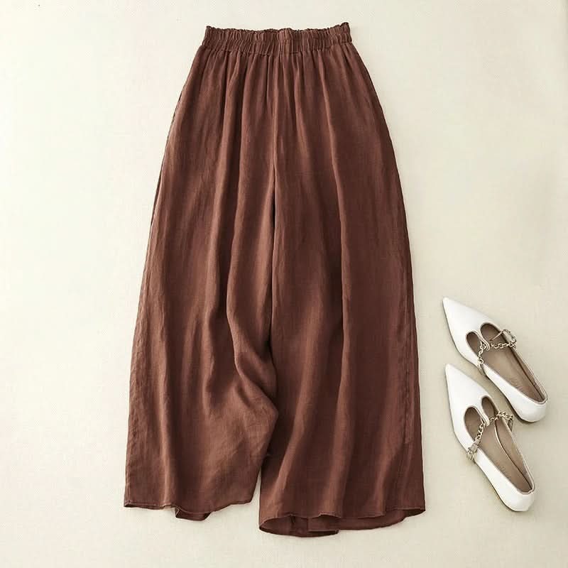 Brown linen pants with elastic waistband and wide, draped legs
