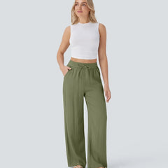 Olive green wide-leg trousers with elastic waistband and drawstring, relaxed legs.