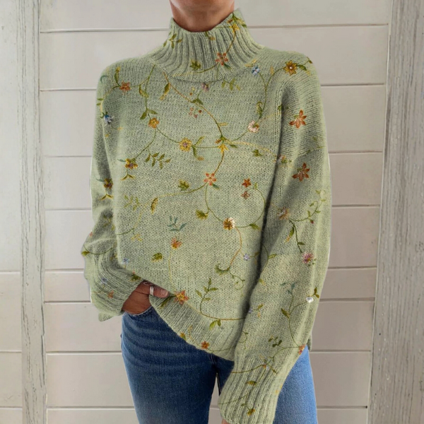 Green luxe pullover with knit turtleneck, long sleeves, and scattered floral pattern