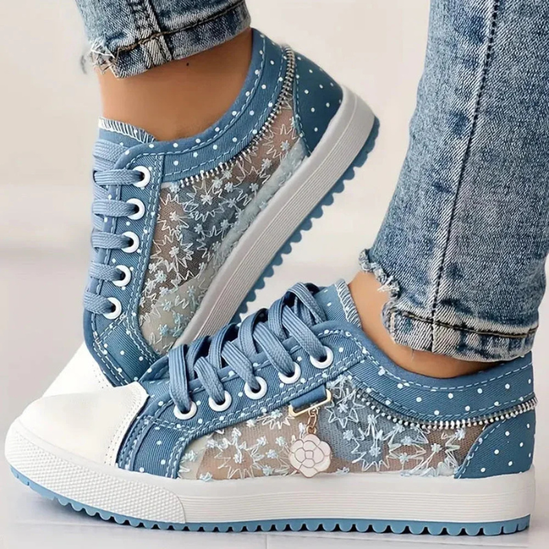 Light blue canvas floral sneakers with polka dots, lace-up front, white rubber toe cap.