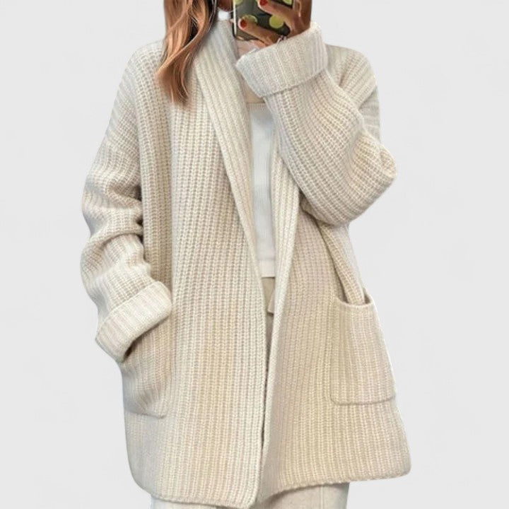 Cream cardigan with shawl collar, open front, and front patch pockets