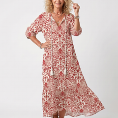 Red ornate print midi dress with tassel tie, three-quarter sleeves, and flared skirt