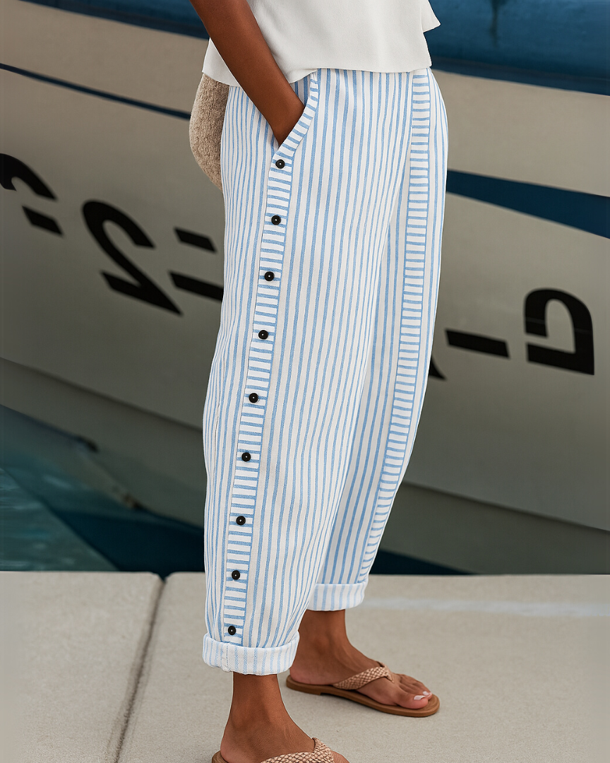 Blue-and-white striped trousers with button placket and cuffed hems