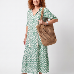 Green patterned V-neck midi dress with short sleeves and loose tiered skirt