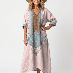 Pink embroidered midi dress with relaxed fit, side pockets, and short sleeves