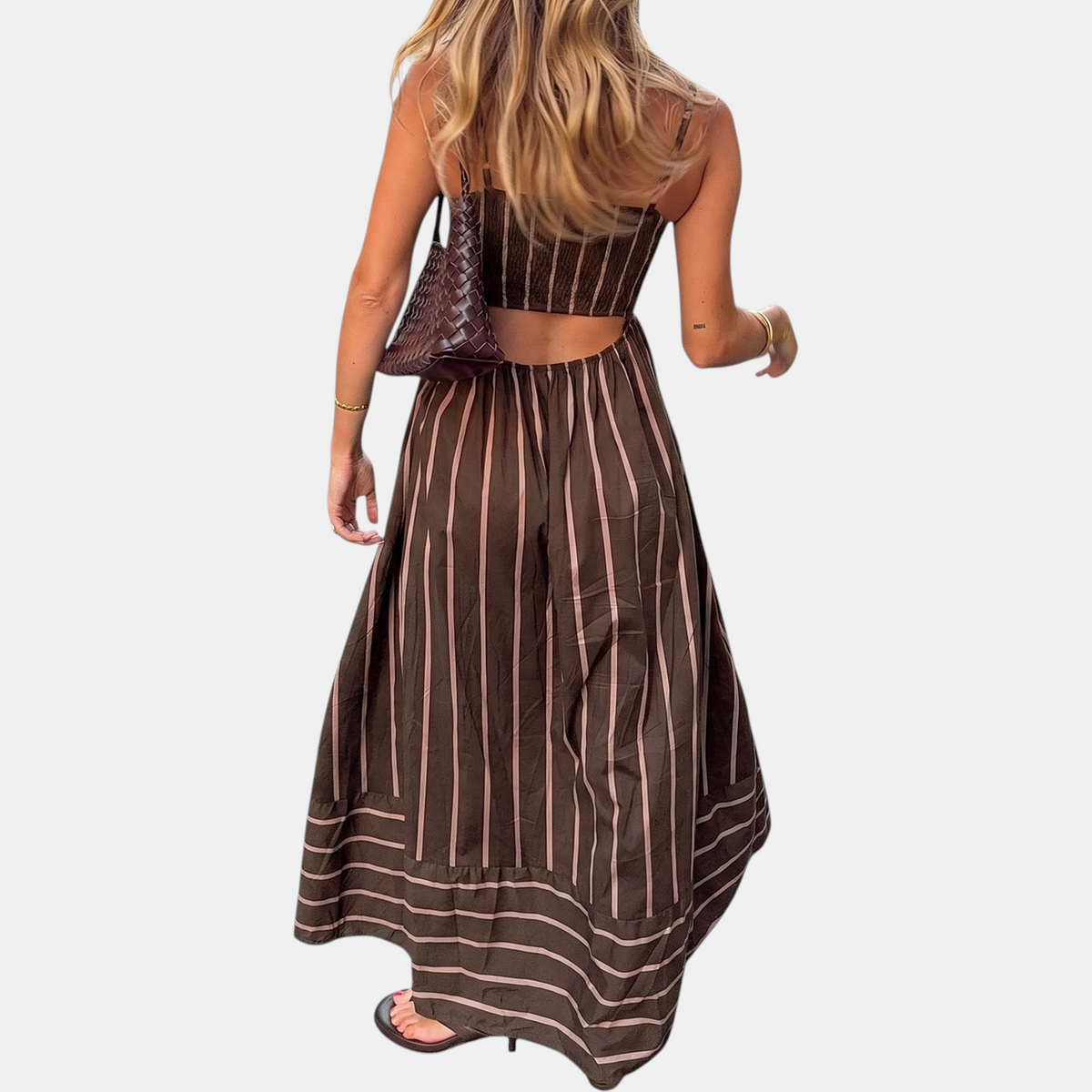 Brown striped maxi dress with thin straps, backless cutout, and gathered full skirt