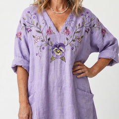 Purple midi dress close-up: floral embroidered V-neck, elbow-length puff sleeves and pocket
