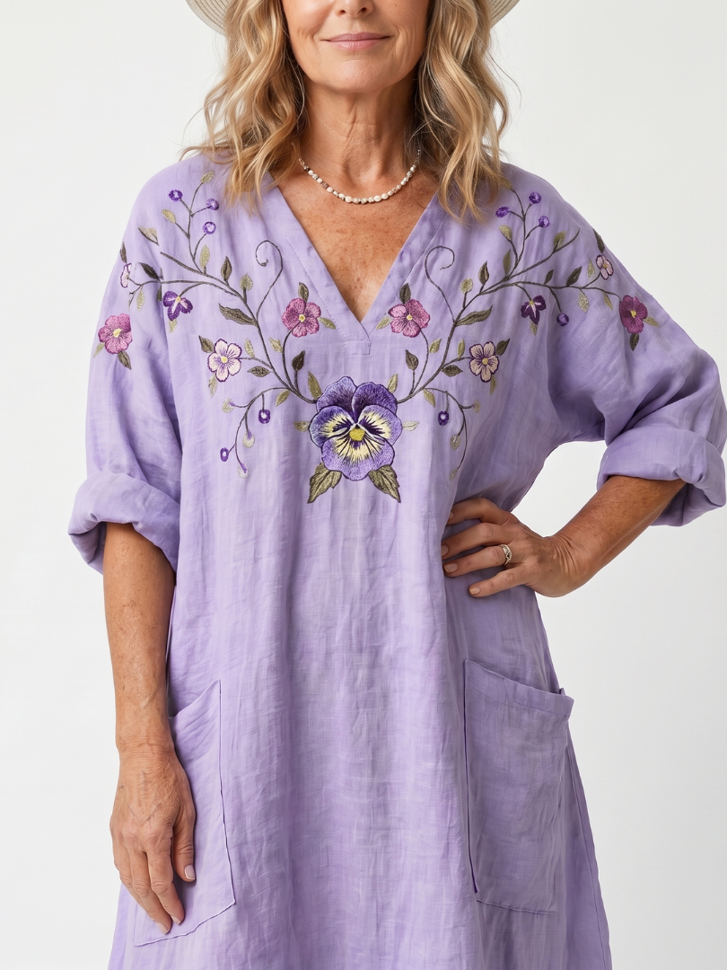 Purple V-neck midi dress with floral embroidery, front pocket, and puff sleeves