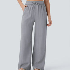 Grey wide-leg trousers with elastic waistband and drawstring ties