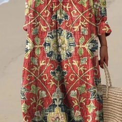 Boho maxi dress, V-neck and long sleeves, red-green floral pattern close-up midsection