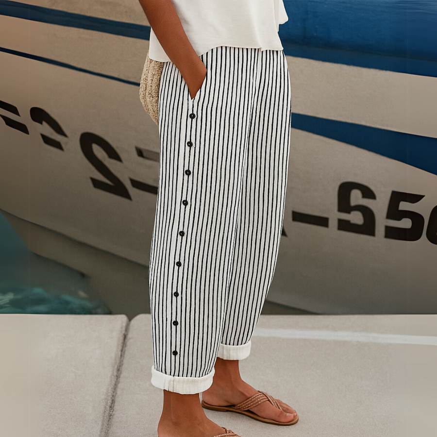 Black-and-white striped trousers with button placket and cuffed hems