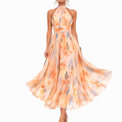 Halter watercolor maxi dress with peach, orange, and blue floral print, flowing tiered skirt
