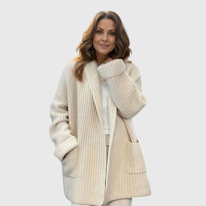 Cream chunky knit cardigan with shawl collar, open front, and patch pockets