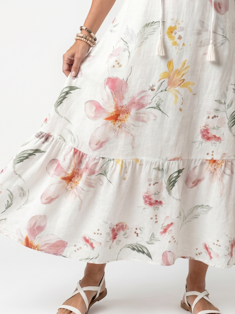 Floral tiered skirt detail on white midi dress with gathered ruffle hem