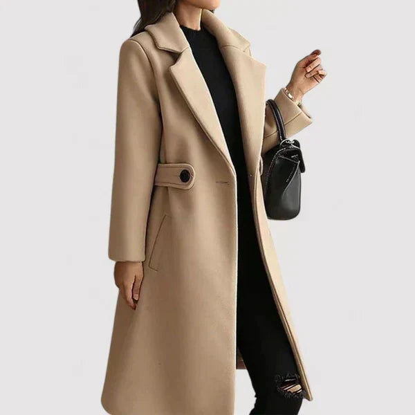 Beige long classic coat with belt tab detail, notched lapels, button front.