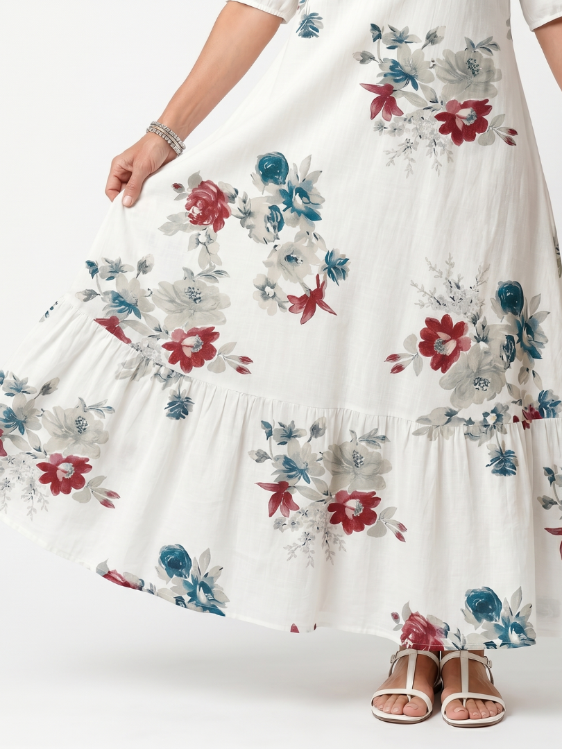 White floral midi dress detail, tiered skirt with multicolor blossom print.
