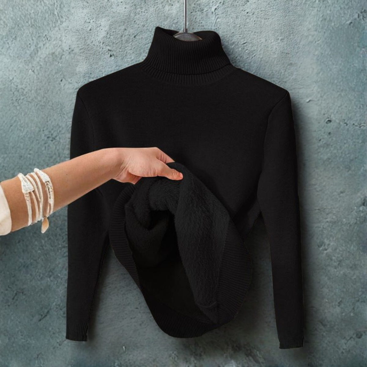 Black turtleneck long-sleeve sweater with ribbed collar; folded scarf draped on front
