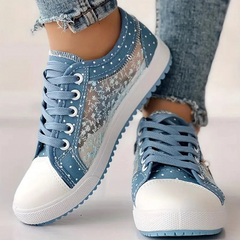 Light blue floral sneakers with lace-up vamp, white toe cap and blue scalloped edge sole.