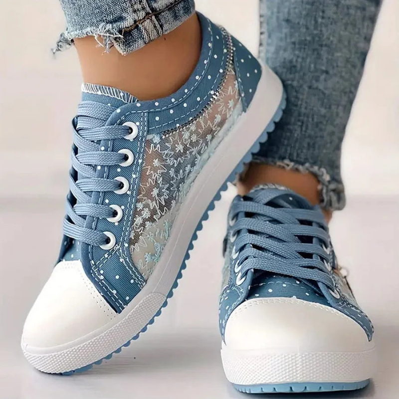 Light blue floral sneakers with lace-up vamp, white toe cap and blue scalloped edge sole.