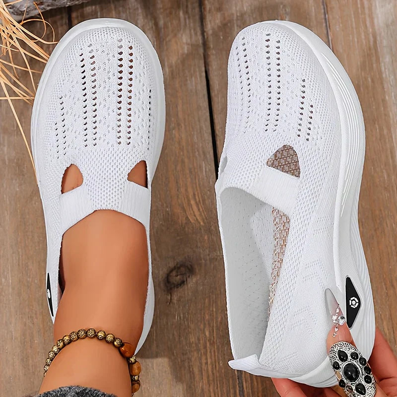White knit slip-on sneakers with side cutouts and cushioned white soles