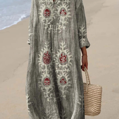 Light green boho maxi dress with red folk motifs, V-neck, long sleeves, roomy maxi length.