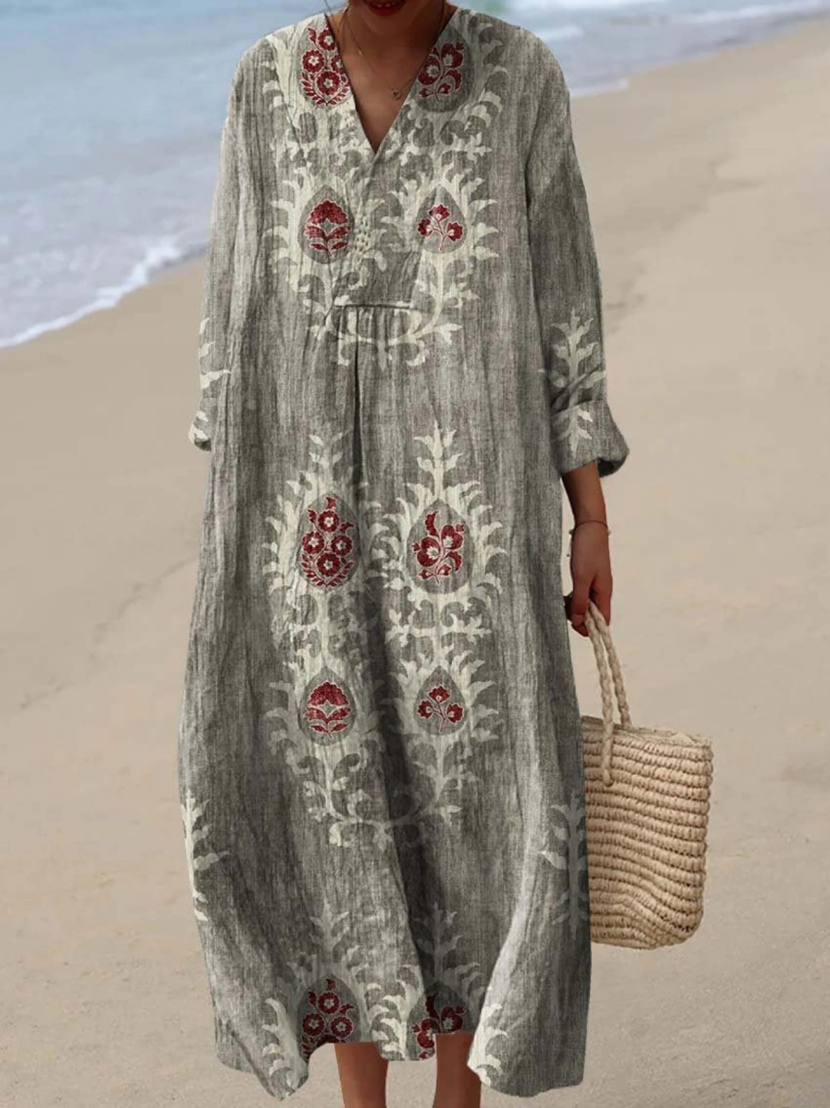 Light green boho maxi dress with red folk motifs, V-neck, long sleeves, roomy maxi length.