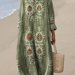 Green boho maxi dress with embroidered folk motifs, V-neck, long sleeves, relaxed fit.