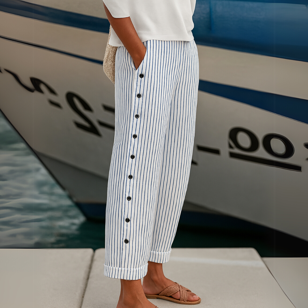 Blue-and-white striped trousers with front button placket and tapered legs