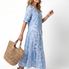 Light blue floral midi dress with V-neck and tiered skirt, side view