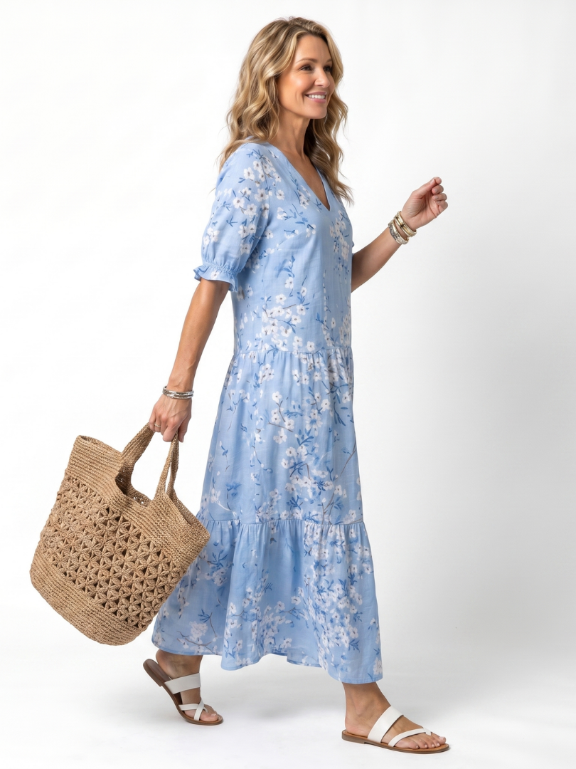 Light blue floral midi dress with V-neck and tiered skirt, side view