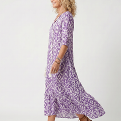 Purple printed midi dress with tie-neck and flowing tiered skirt, side view