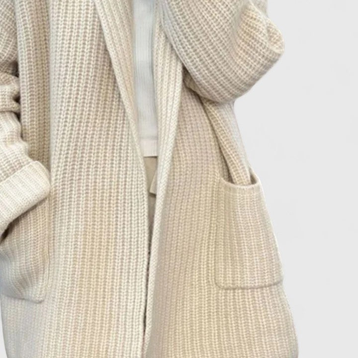 Cream knit cardigan front with open placket and patch pocket detail