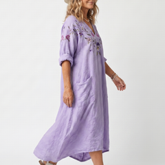 Purple floral pocket midi dress, side view, V-neck with embroidered details