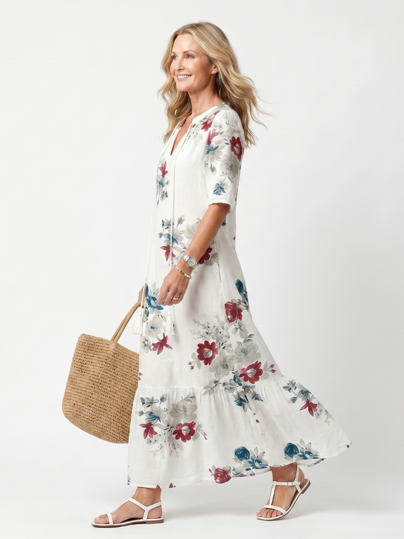 White floral midi dress, short sleeves, tiered hem, side view with tie neckline.