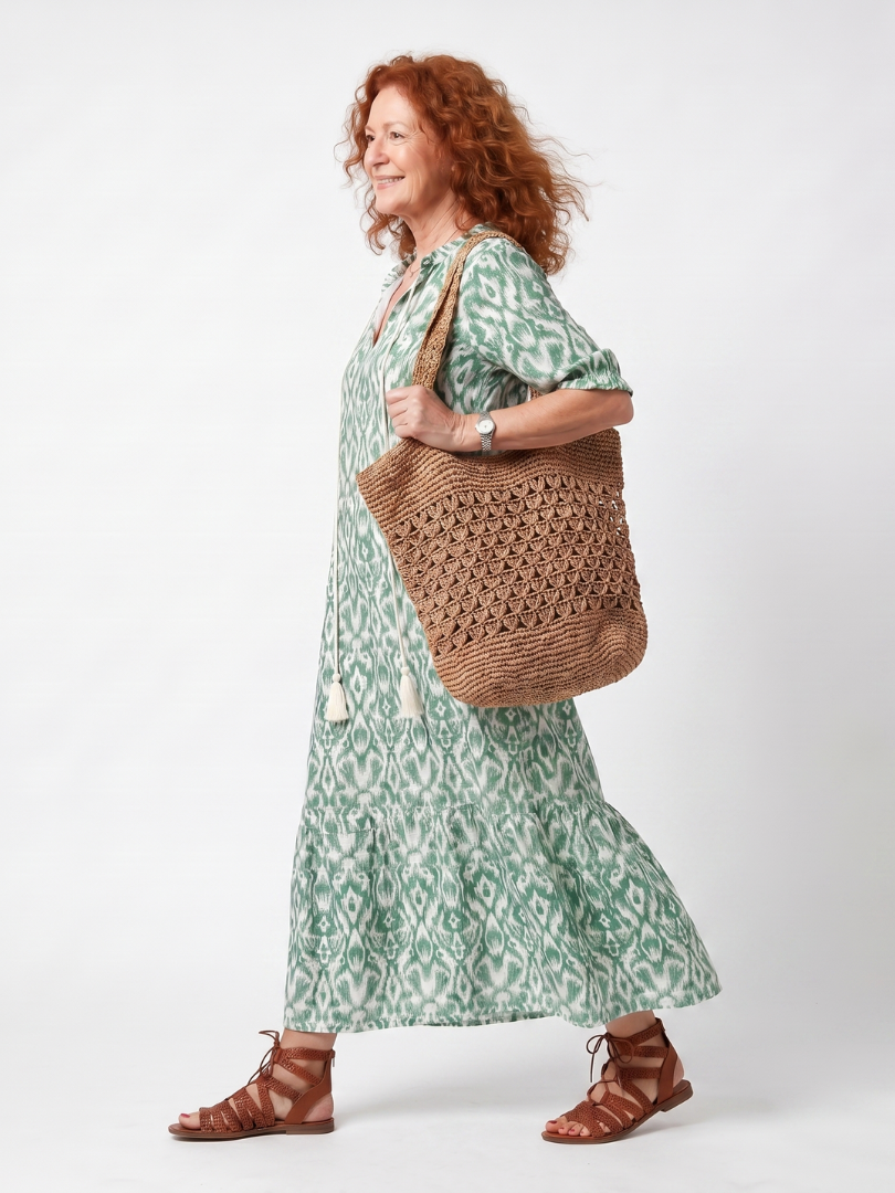 Green patterned V-neck midi dress with short sleeves and tiered skirt, side view