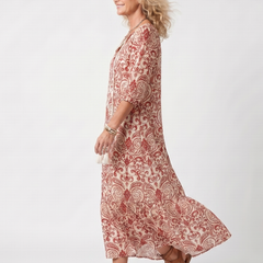 Red paisley tie-neck midi dress, side view with flared skirt and 3/4 sleeves