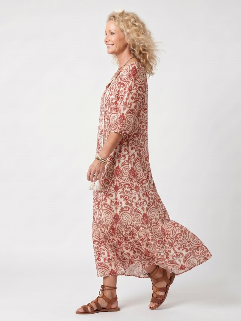 Red paisley tie-neck midi dress, side view with flared skirt and 3/4 sleeves