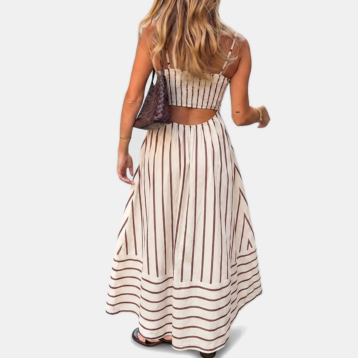 White striped maxi dress with thin straps, back cutout, and gathered full skirt