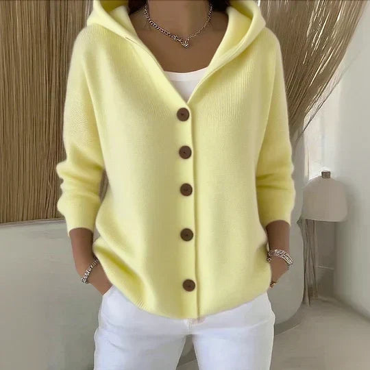 Soft yellow hooded button-up knit cardigan with dark buttons, long sleeves